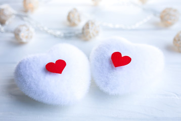 Red and white hearts on wooden background. Saint Valentine's day concept. Love and romantic photo. Postcard for holiday. Small rustic lights.