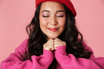 Canvas Print - Image of beautiful asian girl smiling and clenching her fists at chest