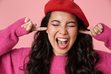 Sticker - Image of upset asian girl screaming and plugging her ears with fingers