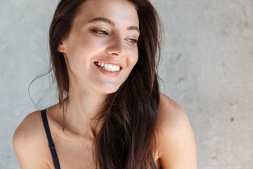 Poster - Close up of a smiling young brunette woman wearing bra