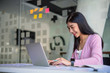 © Songsak C - Portrait of pretty young woman using her laptop in the office.