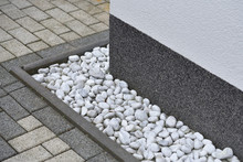 Pebbles For Drainage Of Water Along The House Next To The Wall. Rainwater Harvesting