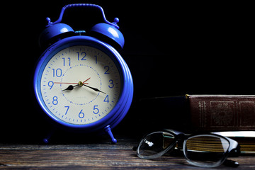 An ancient alarm clock placed on the table