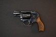 Black snubnose revolver isolated on black background. 