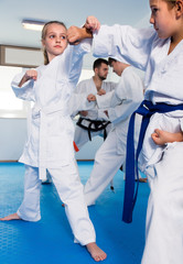 Wall Mural - Young children sparring in pairs in karate class