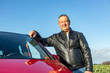 © Edler von Rabenstein - Man is standing next to his car
