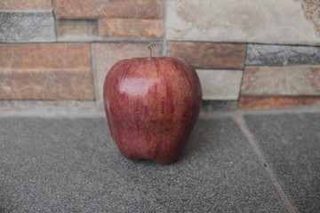 red apple on wooden table