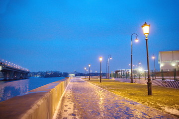 promenade with lanterns on a dark winter evening