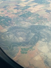 a river winding through a mixed surface landscape