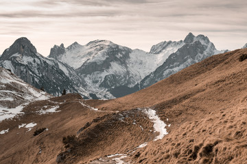 Leinwandbilder - snow covered hiking trail in front of alpstein massif