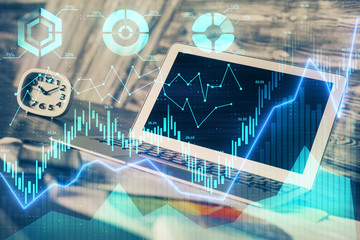 Double exposure of chart and financial info and work space with computer background. Concept of international online trading.