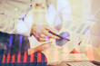 © peshkova - Financial trading graph double exposure with man desktop background.