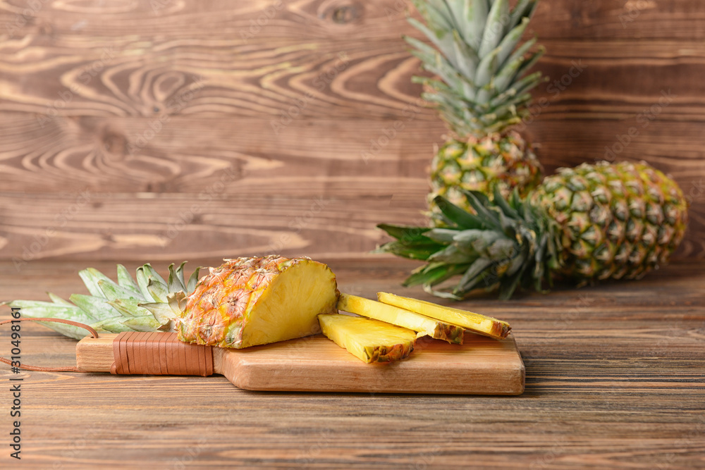 Fresh ripe pineapples on wooden background