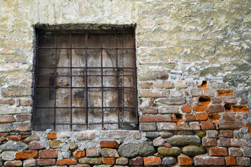 Sticker - Close-up of an old, weathered brick wall with a closed square window, Alba, Cuneo, Piedmont, Italy 