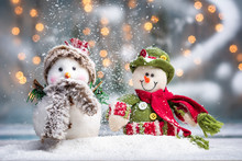 Two Snowman With Festive Illuminated Christmas Holiday Background