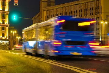 Poster - blurred image of a bus traveling in Moscow at night