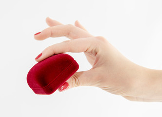 Velvet red gift box in a woman's hand