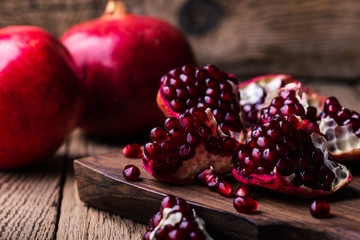 Wall Mural - Fresh ripe whole pomegranates,  opened pomegranate  and  seeds