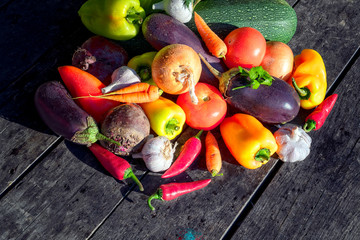 Wall Mural - Fresh organic vegetables on a background of an old wooden table.