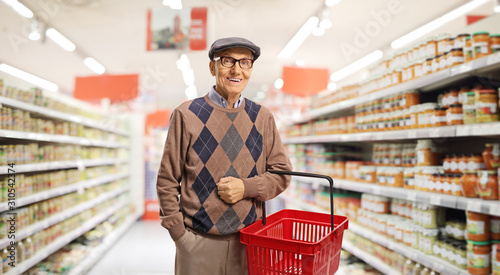 Senior with a shopping basket Tableau sur Toile