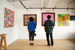 © Mint Images - Rear view of Japanese man and woman looking at abstract painting in an art gallery.