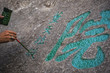 © Pav-Pro Photography  - Man painting chinese calligraphy characters on a rock