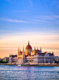 Fototapeta Big Ben - The Hungarian Parliament Building located on the Danube River in Budapest Hungary at sunset.