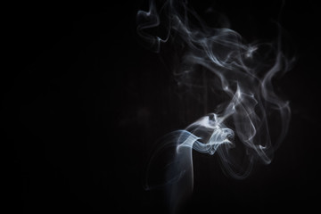 Abstract smoke swirls on black background