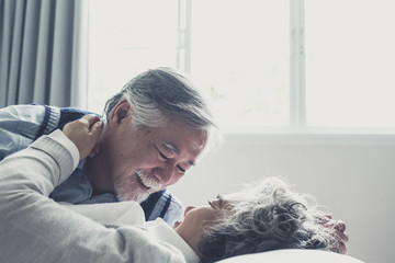 Wall Mural - elderly couple caucasian lovely senior man and woman sleep on bed and smiling in bedroom, retirement health care with love lifestyle concept