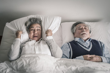 Wall Mural - elderly couple caucasian senior woman and man sleep on bed and snoring in white blanket in bedroom, retirement health care with love lifestyle concept