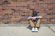 © soupstock - Depressed upset student sitting outside school