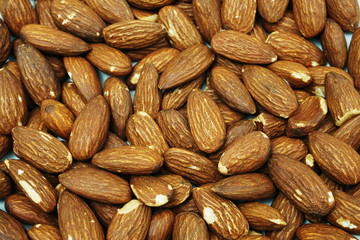 Wall Mural - Top view brown Almond nuts close up background