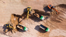 Aerial View Group Of Excavator And Dump Truck Working On A Construction Site, Construction Site View From Above.