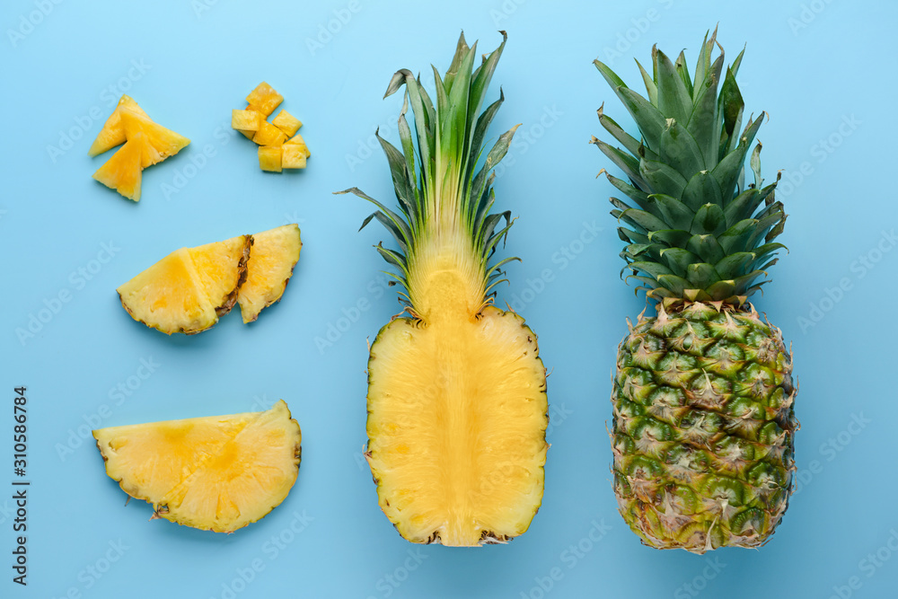 Fresh ripe pineapples on color background