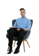© New Africa - Handsome young man with clipboard sitting in armchair on white background