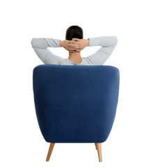 Poster - Young man sitting in armchair on white background, view from back