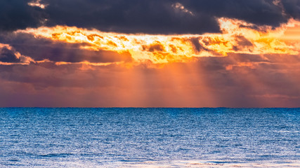 Wall Mural - Sun bursting through storm clouds at sunset, Santa Cruz, California