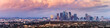 Panoramic view of downtown Los Angeles skyline at sunset, colorful storm clouds covering the sky; California