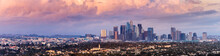 Panoramic View Of Downtown Los Angeles Skyline At Sunset, Colorful Storm Clouds Covering The Sky; California