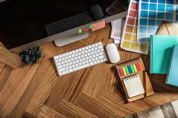 Poster - Designer's workplace with modern computer and color palettes, flat lay. Space for text