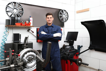 Wall Mural - Professional worker in shop of modern tire service