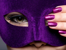 Woman With Purple Nails And Violet Theatre Mask On Face.