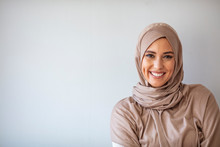 Portrait Of Pretty Young Asian Muslim Woman In Head Scarf Smile. Portrait Closeup Of Muslim Prayer Woman 20s In Hijab Smiling Isolated Over Gray Background.