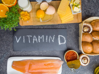 Wall Mural - Food sources of vitamin D, including fish, egg, dairy, mushrooms, greenery, caviar, orange, corn