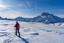 Active Senior Woman Snowshoeing Under The Famous Three Peaks From Prato Piazzo Up To The Monte Specie In The Three Oeaks Dolomites Area Near Village Of Innichen, South Tyrol, Italy