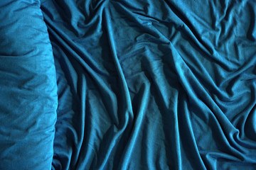 Roll of elegant sea color textile. Textile folds background.