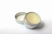 Lip Balm In The Round Metallic Tins On The White Background