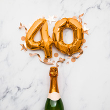 Champagne Bottle With Gold Number 40 Balloon. Minimal Party Anniversary Concept