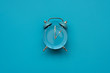 Time to eat. Plate with cutlery as clock on blue background. Top view. Flat lay. Weight loss and diet concept
