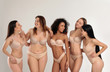 © New Africa - Group of women with different body types in underwear on light background